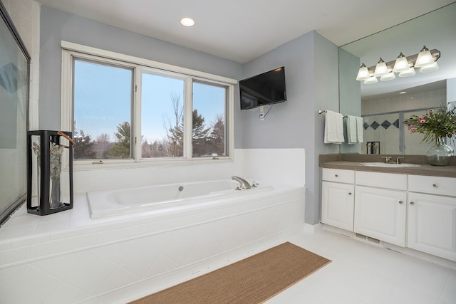 bathroom featuring a stall shower, visible vents, a bath, and vanity