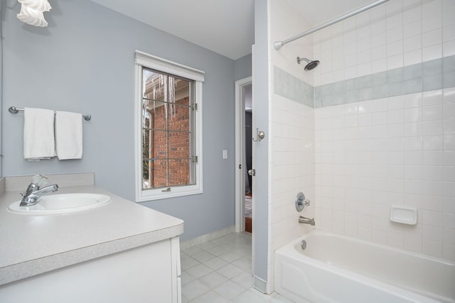 full bath featuring shower / bathtub combination, tile patterned floors, baseboards, and vanity