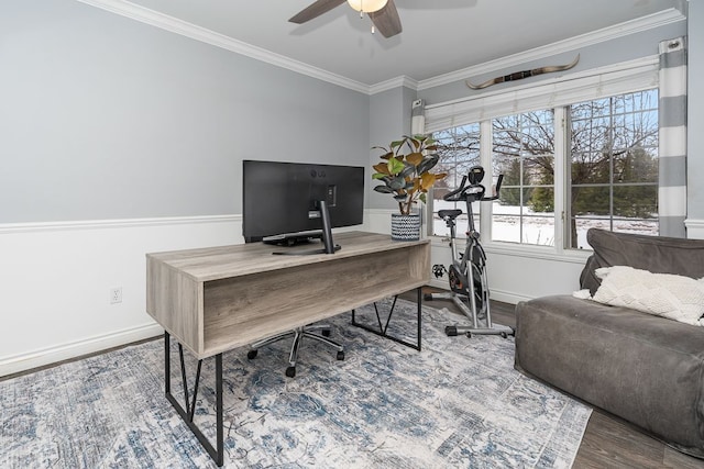 office area with ornamental molding, a ceiling fan, baseboards, and wood finished floors