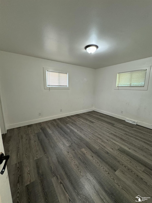 empty room with dark hardwood / wood-style floors