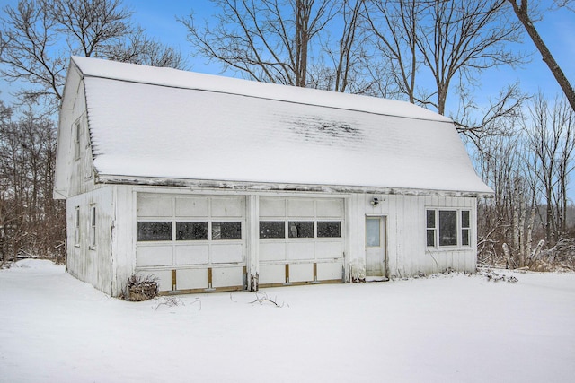 view of front of property with a garage and an outbuilding