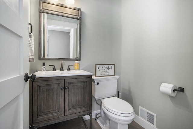 bathroom with vanity and toilet