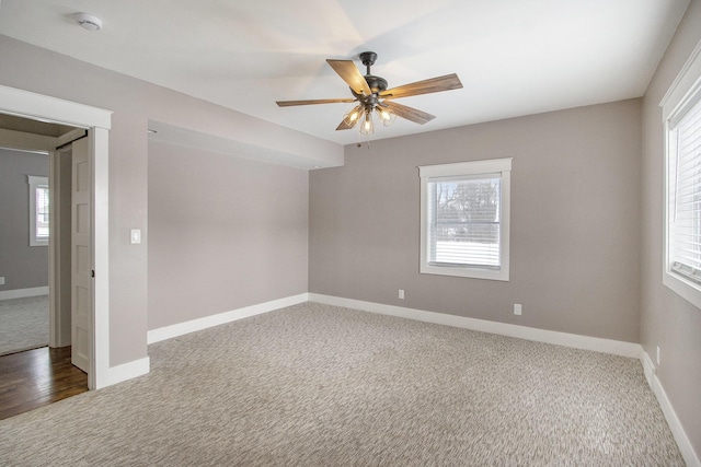 carpeted spare room featuring ceiling fan