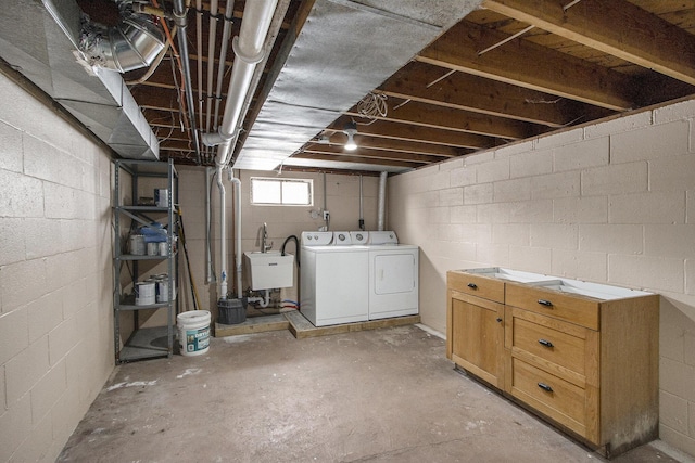 basement featuring washer and dryer and sink