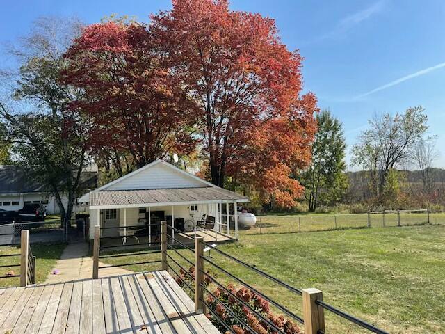 deck featuring a yard and a rural view