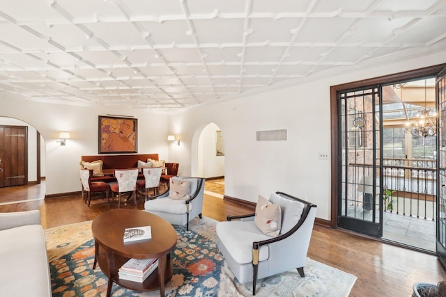 living room with wood-type flooring and a chandelier