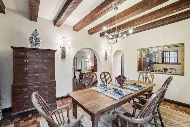 dining space with beamed ceiling and an inviting chandelier