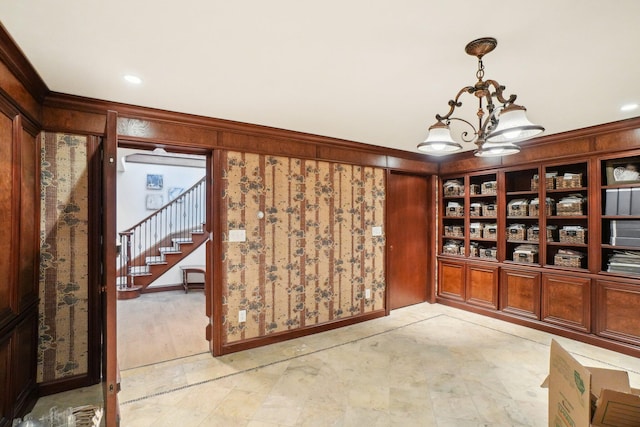 wine room featuring a notable chandelier and ornamental molding