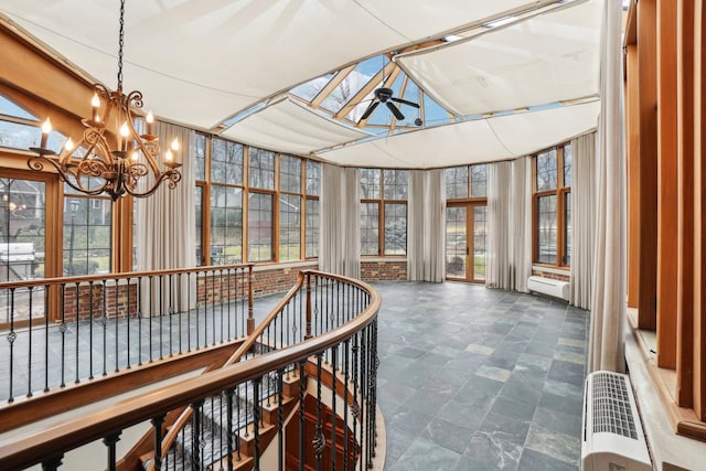 sunroom featuring baseboard heating, ceiling fan, and a skylight