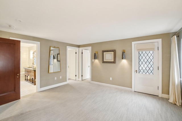 interior space with light colored carpet and connected bathroom