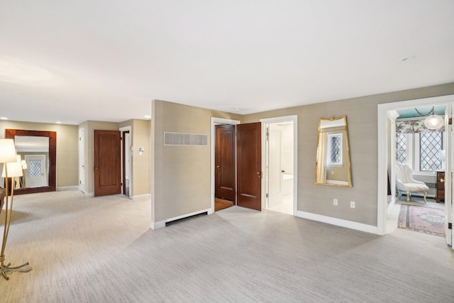 unfurnished living room with light colored carpet