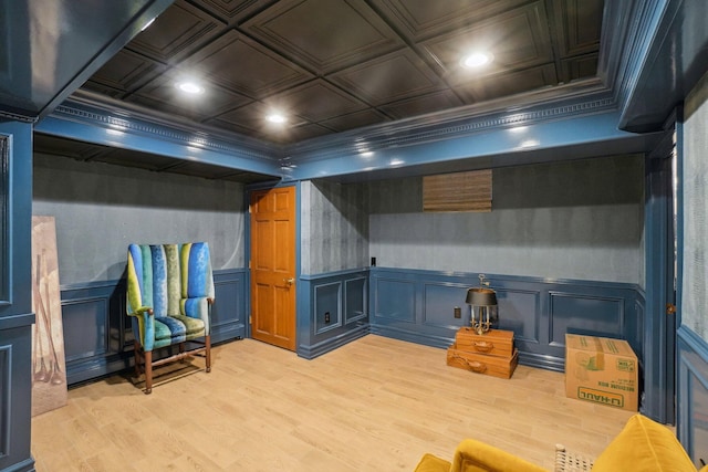 basement featuring crown molding and light hardwood / wood-style flooring