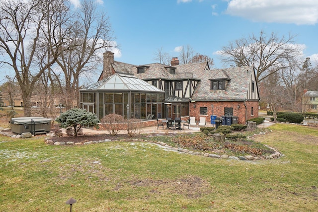 rear view of property featuring cooling unit, a yard, a hot tub, a sunroom, and a patio area