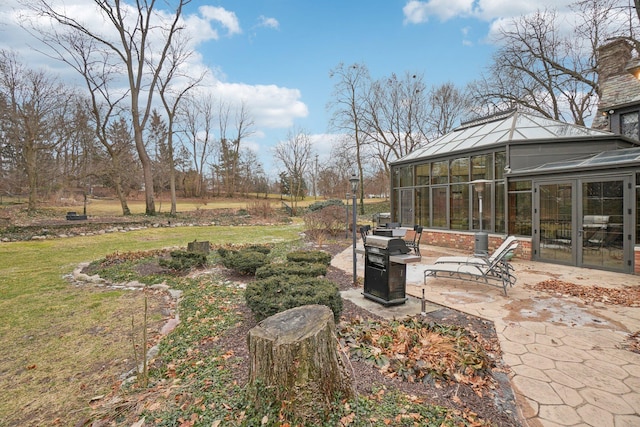 view of yard with a sunroom and a patio