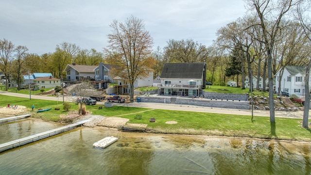 exterior space featuring a water view and a yard