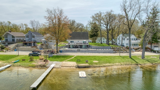 dock area featuring a yard and a water view