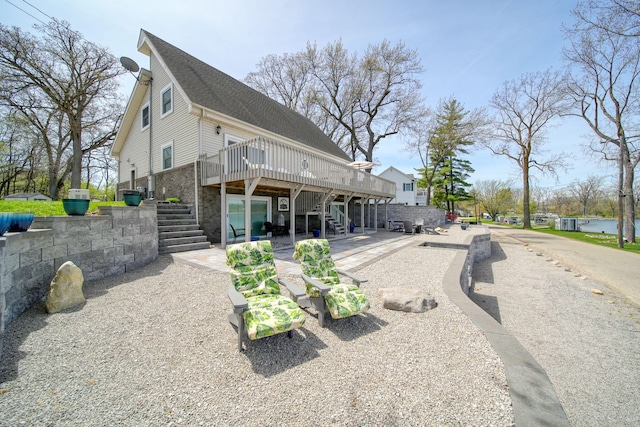 rear view of house featuring a deck, stairs, and a patio area