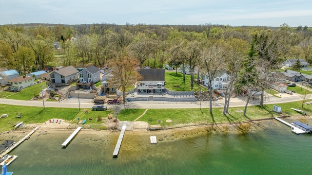 bird's eye view featuring a water view, a residential view, and a forest view