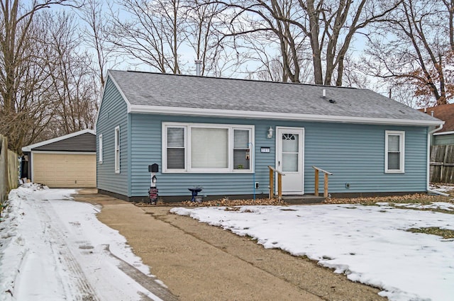 view of front of property with a garage and an outdoor structure