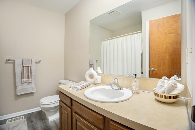 bathroom with hardwood / wood-style flooring, vanity, and toilet