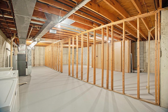 basement with heating unit and independent washer and dryer