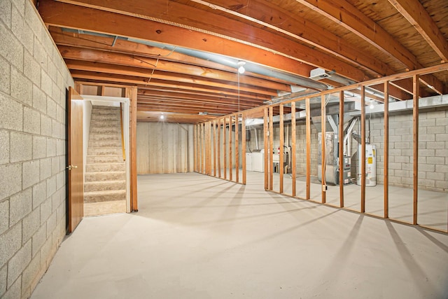 basement with heating unit, separate washer and dryer, and water heater