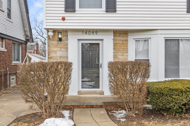 entrance to property featuring stone siding