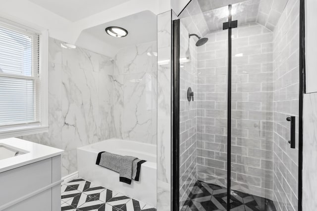 full bathroom featuring a stall shower, vanity, a bath, and tile walls