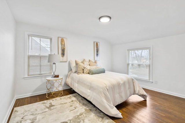 bedroom featuring baseboards and wood finished floors