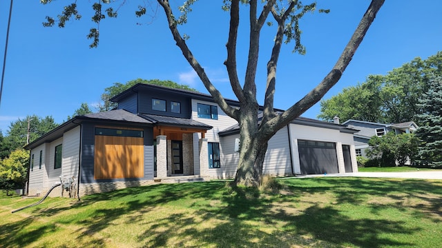 view of front of property with a garage and a front lawn