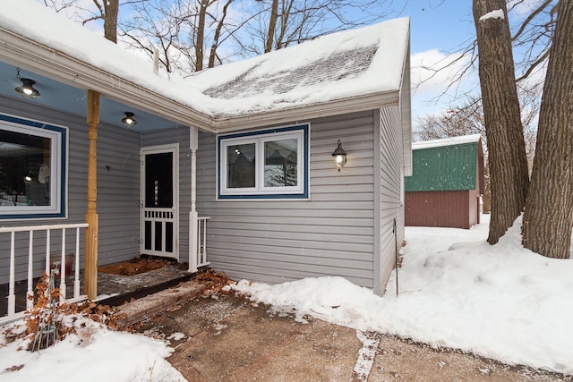 view of snow covered property entrance