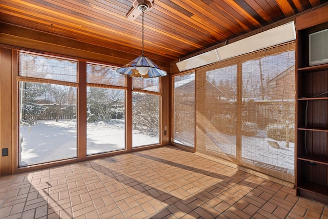 unfurnished sunroom with wood ceiling