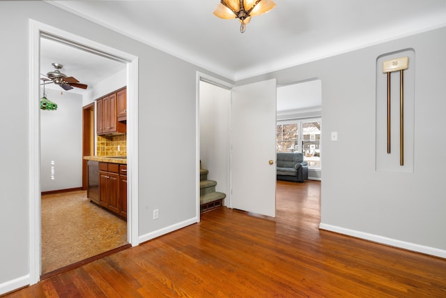 spare room featuring ceiling fan and dark wood-type flooring