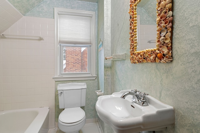 bathroom featuring sink, toilet, a bathing tub, and tile patterned floors