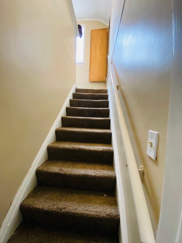 staircase featuring lofted ceiling