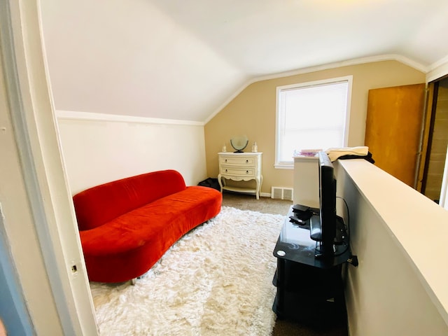 sitting room featuring vaulted ceiling and carpet floors