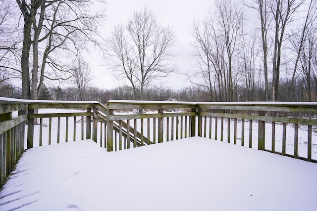 snow covered deck with a water view