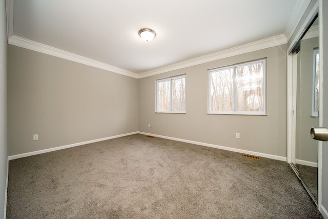 carpeted spare room with ornamental molding