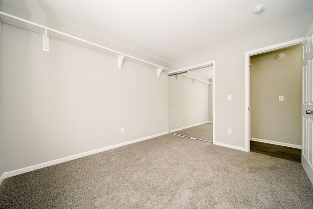 unfurnished bedroom with carpet floors and a closet