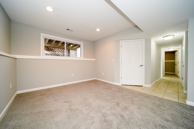 carpeted spare room with lofted ceiling