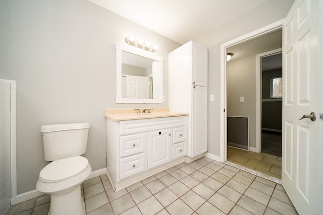 bathroom featuring tile patterned flooring, vanity, and toilet