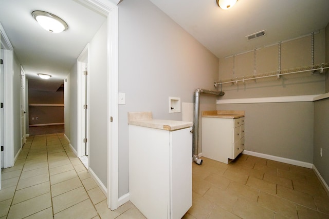 laundry room with cabinets, hookup for a washing machine, and light tile patterned floors