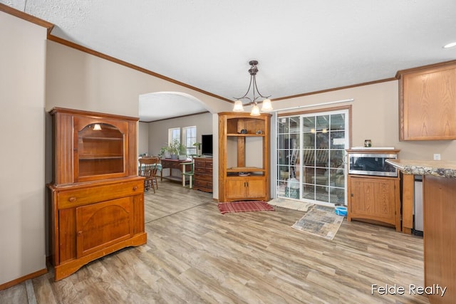 dining room with crown molding and light wood-type flooring