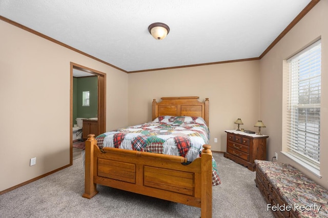 carpeted bedroom featuring ornamental molding and connected bathroom