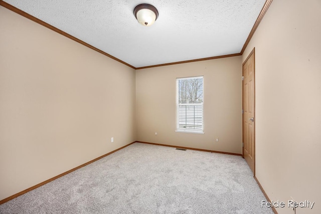 spare room with crown molding, light colored carpet, and a textured ceiling