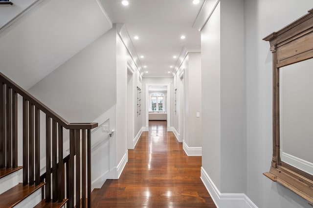 hallway featuring recessed lighting, baseboards, stairs, dark wood finished floors, and crown molding