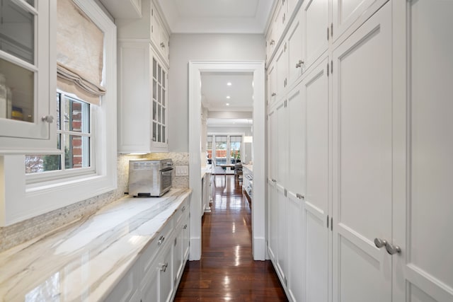 hallway with a toaster, dark wood-style flooring, crown molding, and recessed lighting