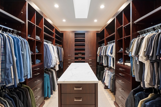 spacious closet featuring a skylight