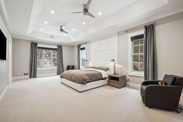 bedroom featuring light carpet, recessed lighting, a raised ceiling, and baseboards