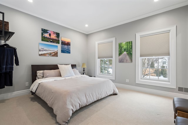 bedroom with baseboards, visible vents, light colored carpet, ornamental molding, and recessed lighting